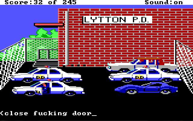 Sonny sits in his cop car in the police station parking lot with the door open. Input text reads: "close fucking door"