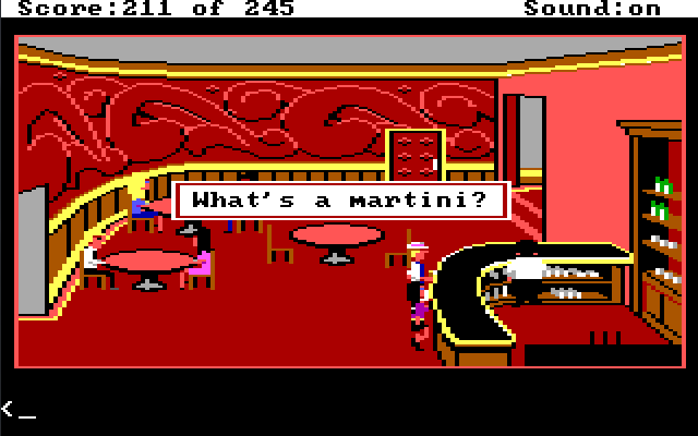 A hotel bar with red walls and carpet. There are a few pink tables and a curved black bar. Sonny stands next to the bar with blond hair, a hat, and a white suit. Marie stands next to him. There is a bartender in a white jacket behind the bar, facing away from them. Game text reads: "What's a martini?"