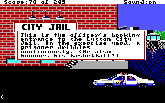 Sonny stands in the parking lot of the jail. Behind a fence is a recreation area where a black prisoner holds a basketball. Game text reads: "This is the officer's booking entrance to the Lytton City Jail. In the exercise yard, a prisoner dribbles continuously. (He also bounces his basketball!)"