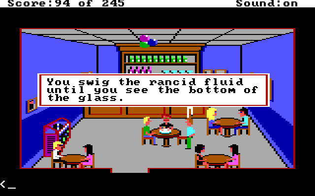 A bar with blue walls and several tables with people at them. Cops in plainclothes are sitting around the center table, which has a birthday cake on it. A red-haired white cop with a mustache sits behind the cake. Game text reads: "You swig the rancid fluid until you see the bottom of the glass."