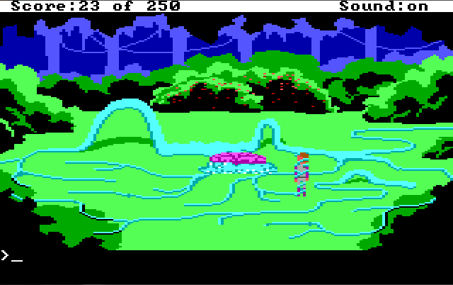 A clearing surrounded by bushes. The bush in the back is covered with red berries. In the center is a purple blob. Blue tentacles extend from it across the entire clearing, forming a narrow maze. Roger stands in the maze, wrapped up in a tentacle.