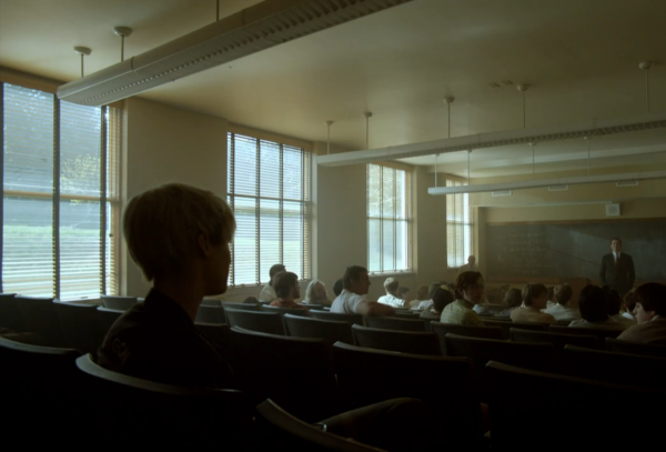 Still from Halt and Catch Fire. The classroom scene. Shot from behind Cameron where she sits in the back, with several empty rows between her and the male students. 