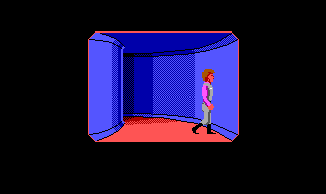 An unusual view of Roger inside a building. In the center of the screen is a first person view of a curving blue corridor with a pink floor. Roger, who looks larger than usual, stands in the near plane of the corridor, running up against the wall.